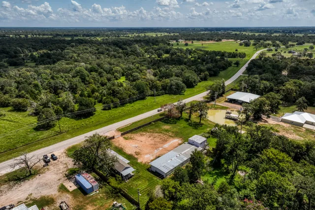 an aerial view of a house with a yard and lake view