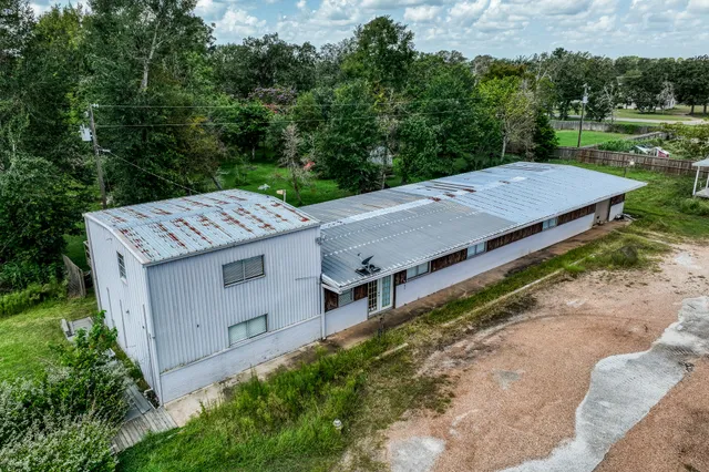 an aerial view of a house with a yard