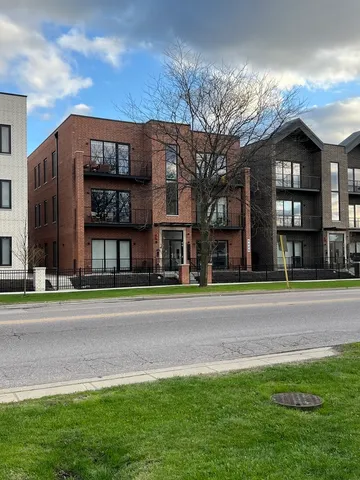 a view of a big house with a big yard and large trees