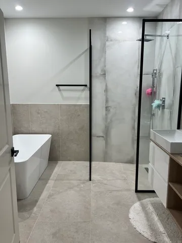 a bathroom with a shower and a sink
