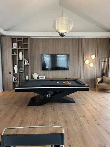 a living room with stainless steel appliances kitchen island granite countertop furniture and a flat screen tv