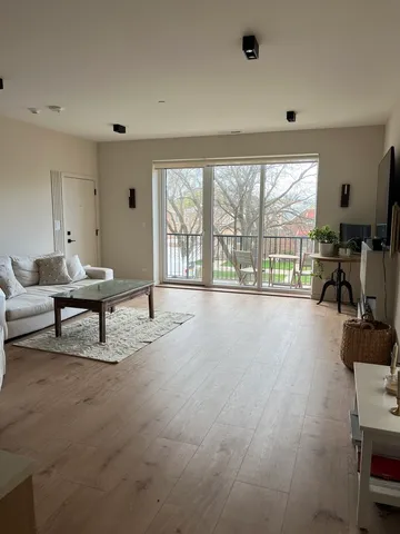 a living room with furniture and a floor to ceiling window