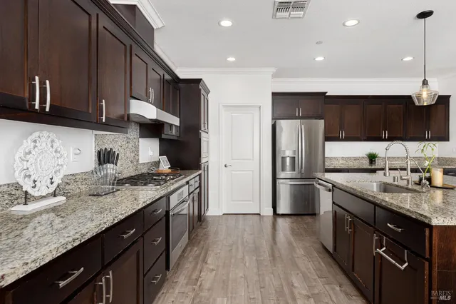a kitchen with kitchen island a sink table and chairs