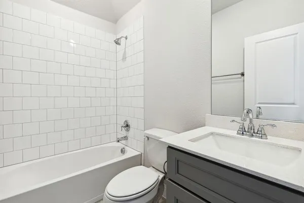 a bathroom with a sink a toilet and bathtub