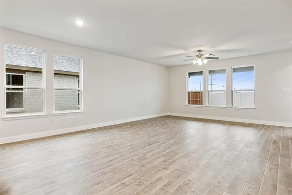 a view of an empty room with windows
