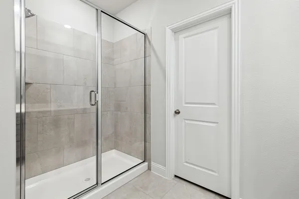 a bathroom with a glass shower door