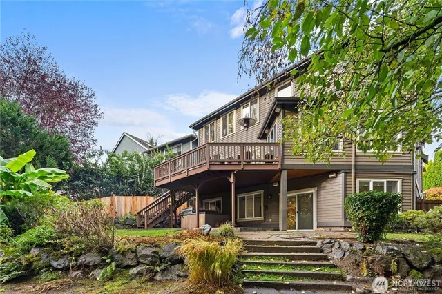 a view of a house with brick walls and flower plants