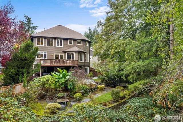 a view of a house with a yard and potted plants