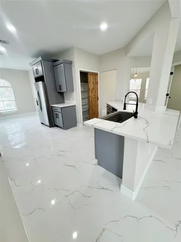 a spacious bedroom with a bed and window