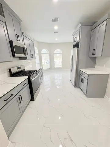 a spacious bathroom with double vanity sinks and a mirror