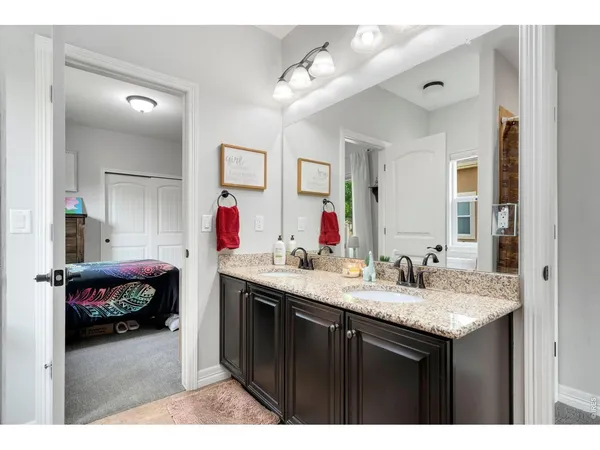 a en suite bathroom with a sink vanity and a mirror