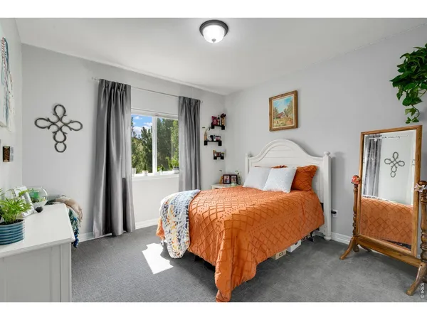 a bedroom with a bed and a potted plant