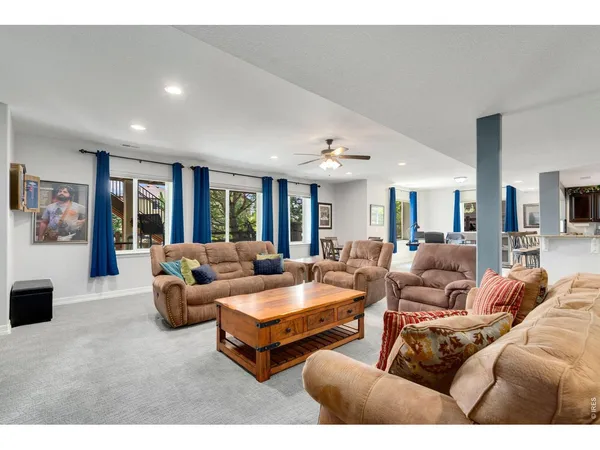 a living room with furniture and large windows