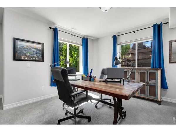 a workspace with furniture and a potted plant