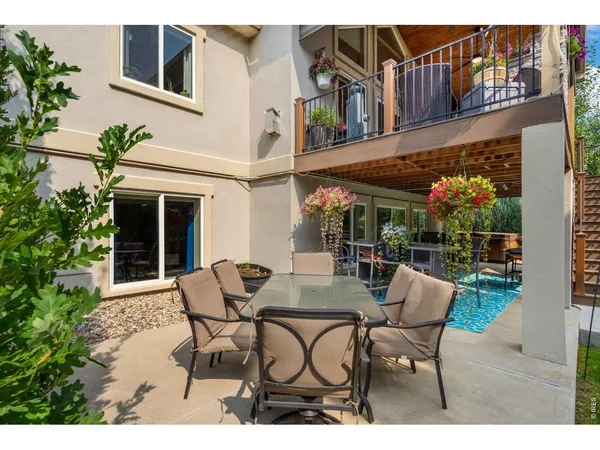 a view of a patio with table and chairs and potted plants