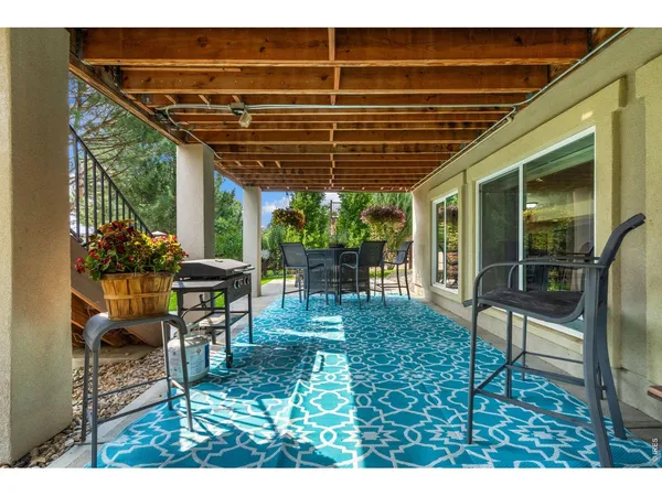 a backyard of a house with table and chairs
