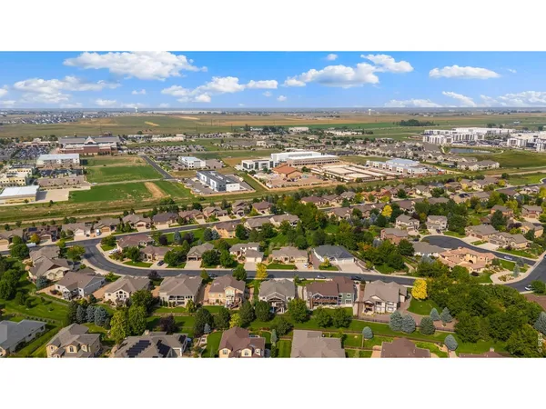 an aerial view of residential houses with city view