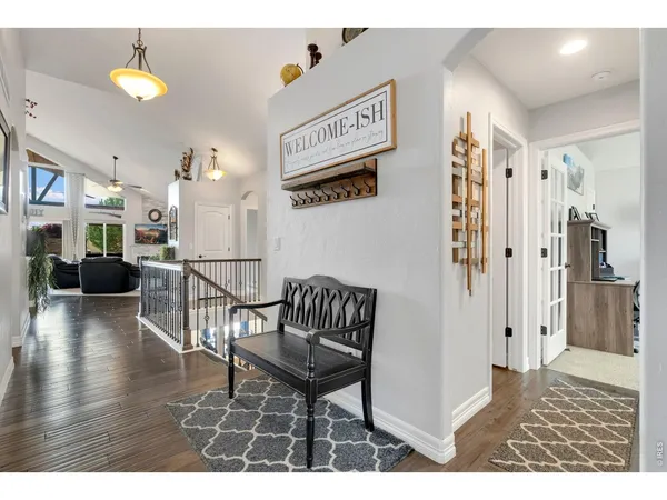 a view of a livingroom with furniture and hardwood floor