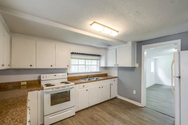 a view of a kitchen with sink and cabinets