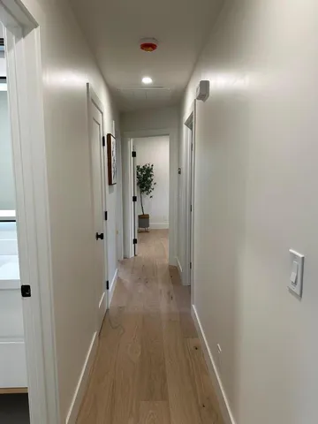 a view of hallway with wooden floor