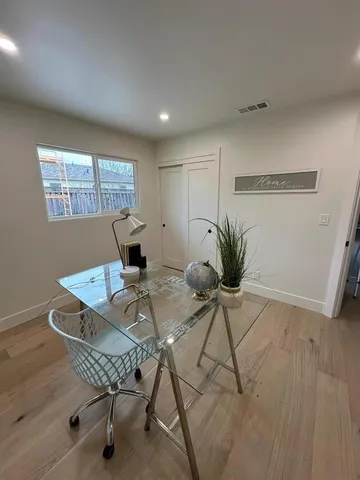 a view of a dining room with furniture and a potted plant