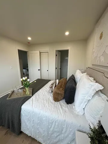 a bedroom with a bed and a couch