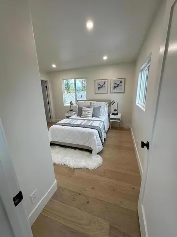 a bedroom with a bed and a window