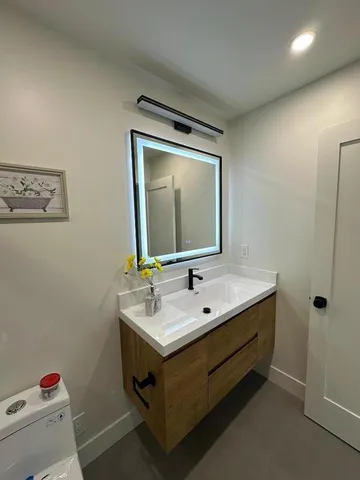 a bathroom with a sink and a mirror