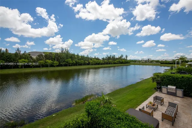 a view of a lake with couches in the house