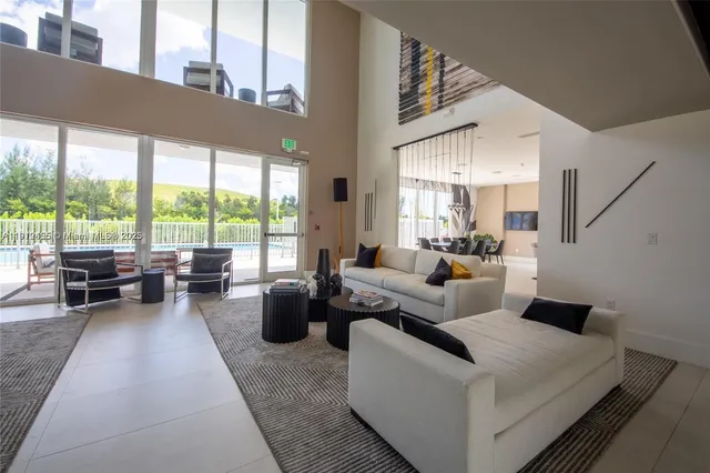 a living room with furniture and large windows