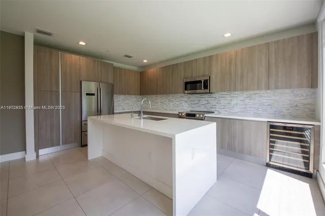 a kitchen with a sink and refrigerator