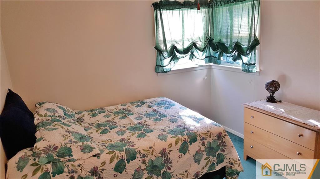 16 Ferris Road Edison, NJ 08817 - Photo 14 of 25 a bedroom with a bed table and a window