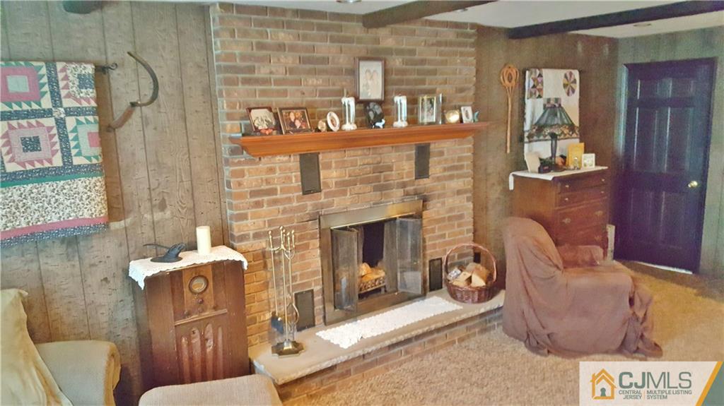 16 Ferris Road Edison, NJ 08817 - Photo 23 of 25 a living room with furniture and a fireplace