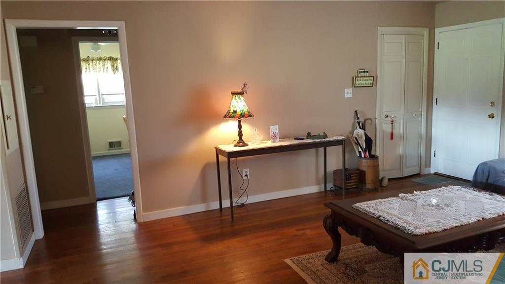 16 Ferris Road Edison, NJ 08817 - Photo 4 of 25 a room with a table chairs and wooden floor