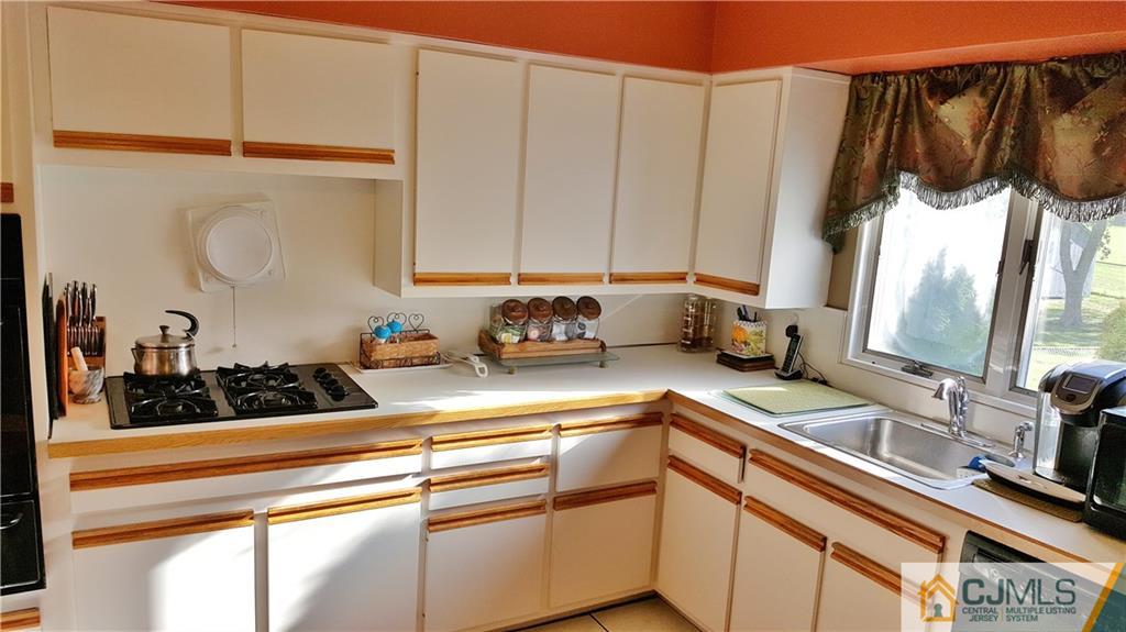 16 Ferris Road Edison, NJ 08817 - Photo 7 of 25 a kitchen with a sink and cabinets