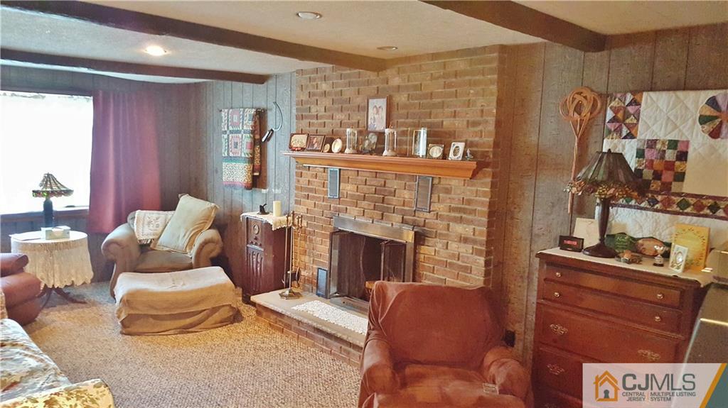 16 Ferris Road Edison, NJ 08817 - Photo 9 of 25 a living room with furniture and a fireplace