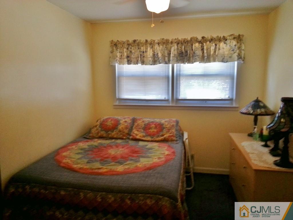 16 Ferris Road Edison, NJ 08817 - Photo 10 of 25 a bed sitting in a room next to a bathroom