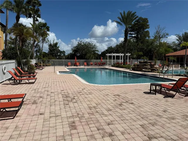 a view of a swimming pool with lounge chair