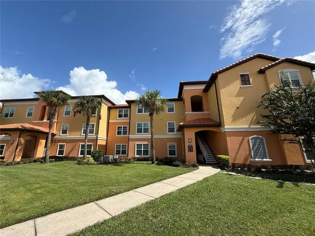 a view of a house with a swimming pool and a yard