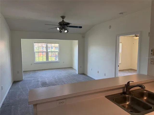 a kitchen with a sink cabinets and window