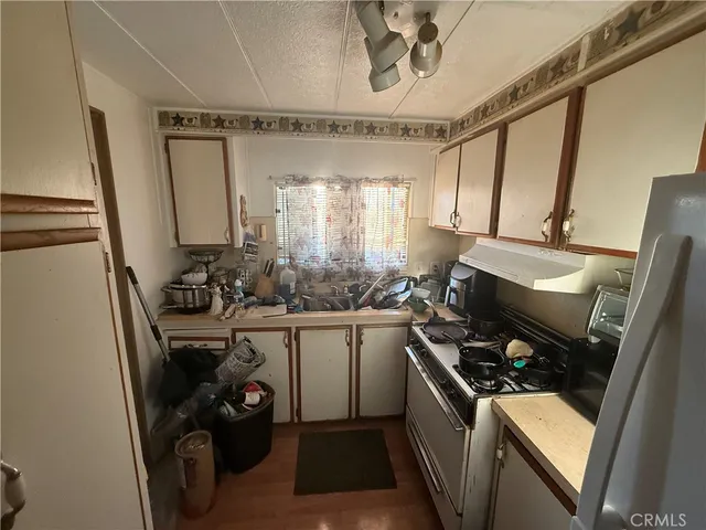 a kitchen with a sink appliances and cabinets