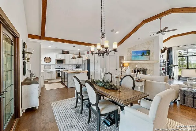 a dining room with furniture and a chandelier