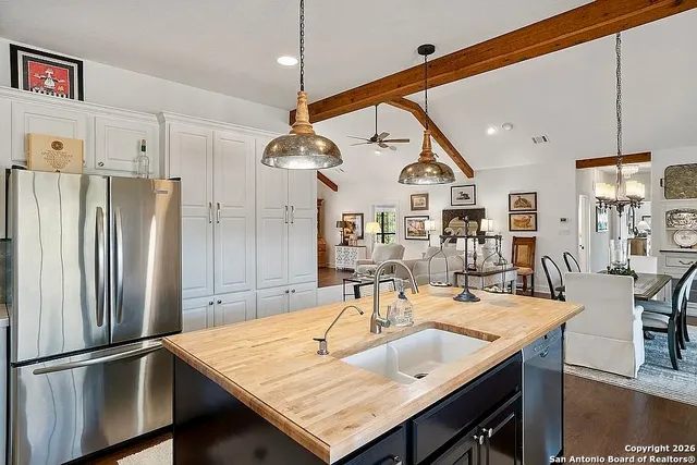 a kitchen with a table chairs and refrigerator