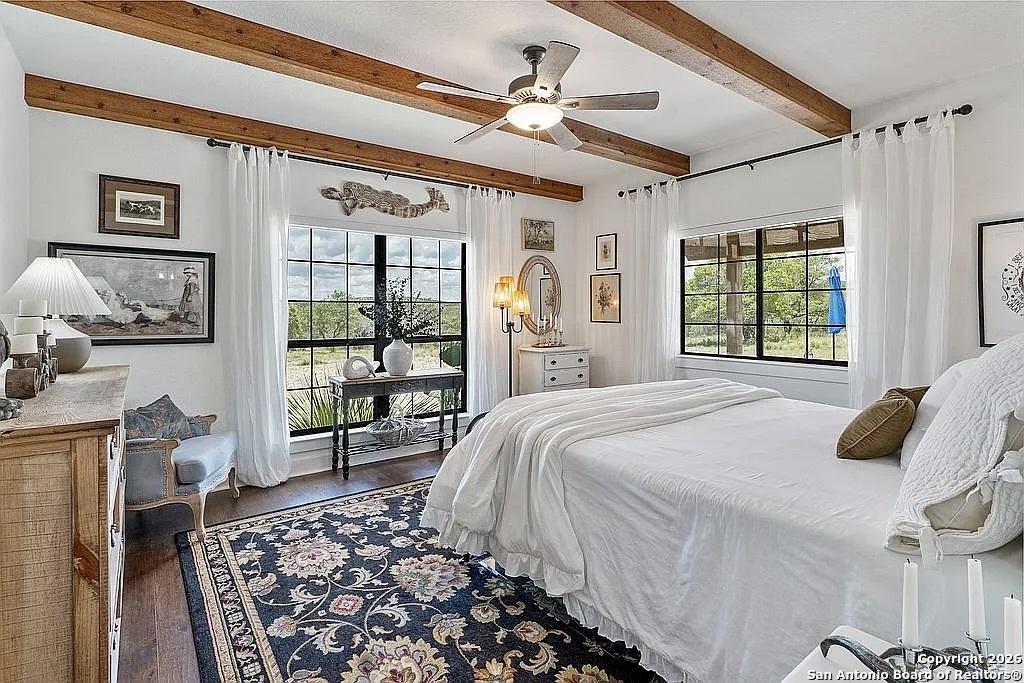 1112 Kendall Jackson Comfort, TX 78013 - Photo 20 of 32 a bedroom with a bed next to a window and a flat screen tv
