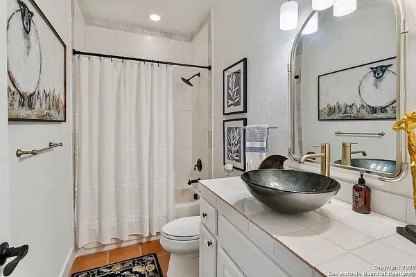 a kitchen with a sink and a stove with wooden floor