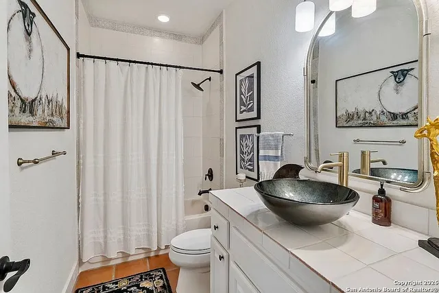 a kitchen with a sink and a stove with wooden floor