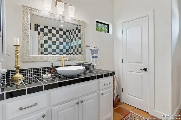 a bathroom with a sink and a mirror