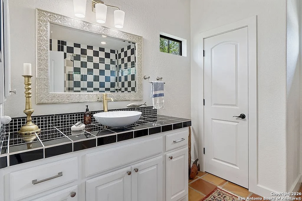 1112 Kendall Jackson Comfort, TX 78013 - Photo 24 of 32 a bathroom with a sink and a mirror