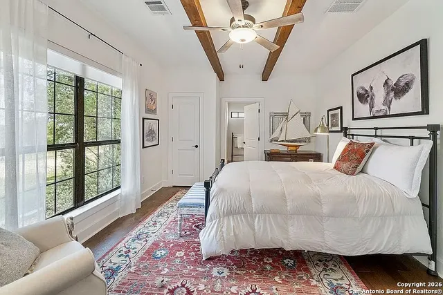 a bed room with a bed a couch and a large window