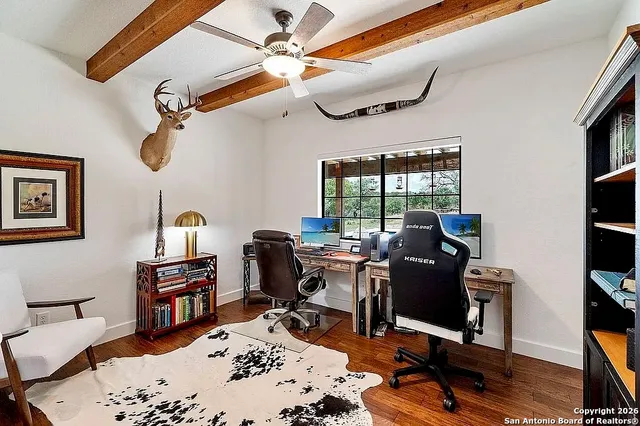 a view of a workspace with furniture and a window